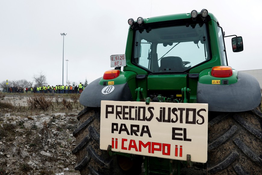 A tractor with a sign reading "Fair Prices for the Countryside" is seen during a protest over price pressures, taxes and green regulation, grievances shared by farmers across Europe, in Vitoria, Spain, February 6, 2024. REUTERS/Vincent West