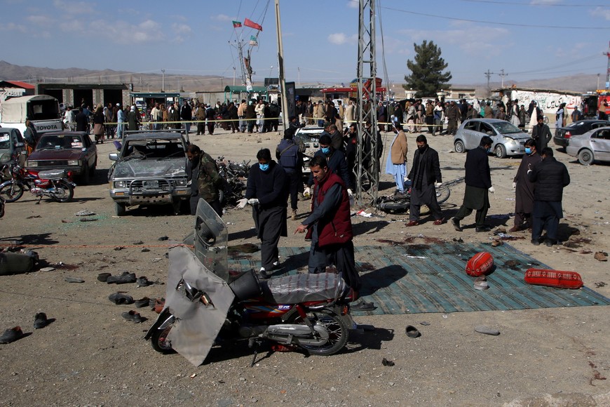 Members of a bomb disposal squad examine the site of a blast in Khanozai, Balochistan, Pakistan, February 7, 2024. REUTERS/Naseer Ahmed