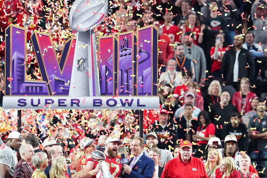 Feb 11, 2024; Paradise, Nevada, USA;  Kansas City Chiefs tight end Travis Kelce (87) celebrates with the Vince Lombardi Trophy after defeating the San Francisco 49ers in Super Bowl LVIII at Allegiant Stadium. Mandatory Credit: Stephen R. Sylvanie-USA TODAY Sports