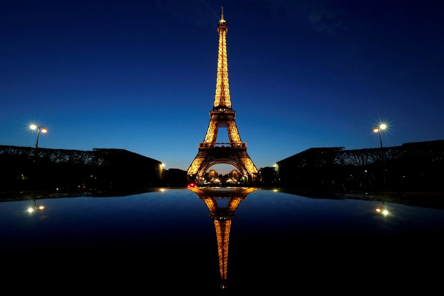 FILE PHOTO: A night view shows the Eiffel tower, reflected in a car's roof, in Paris, France, April 30, 2016. REUTERS/Christian Hartmann/File Photo