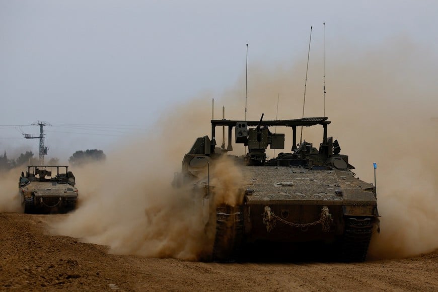 Israeli armoured personnel carriers (APCs) maneuver near the Israel-Gaza border, amid the ongoing conflict between Israel and the Palestinian Islamist group Hamas, as seen from Israel, February 23, 2024. REUTERS/Susana Vera