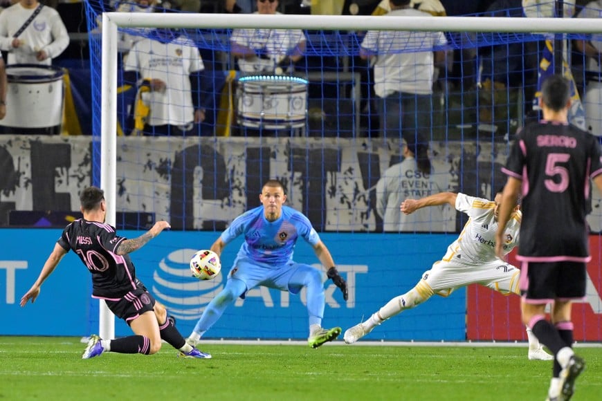 Feb 25, 2024; Carson, California, USA; Inter Miami CF forward Lionel Messi (10) scores against LA Galaxy goalkeeper Jonathan Bond (1) during the second half at Dignity Health Sports Park. Mandatory Credit: Jayne Kamin-Oncea-USA TODAY Sports