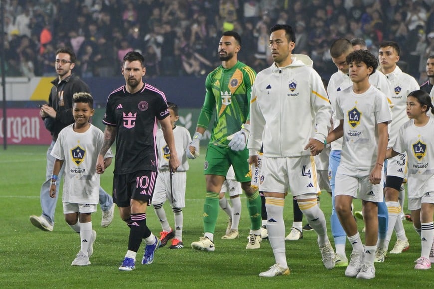 Feb 25, 2024; Carson, California, USA; Inter Miami CF forward Lionel Messi (10) and LA Galaxy defender Maya Yoshida (4) lead their teams onto the field before kickoff at Dignity Health Sports Park. Mandatory Credit: Jayne Kamin-Oncea-USA TODAY Sports