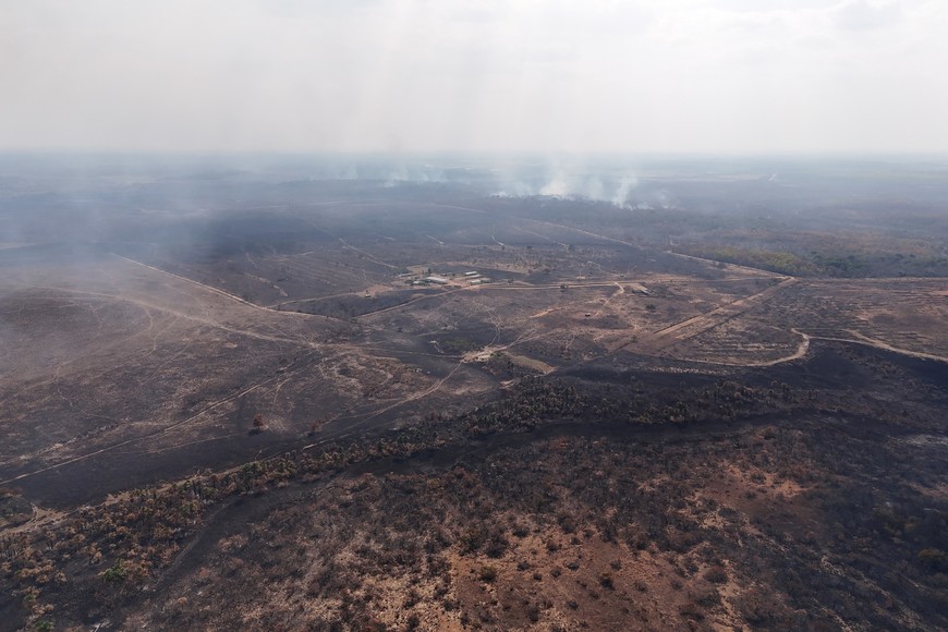 A drone view of smoke from burning vegetation rises in a rainforest at the municipality of Bonfim, state of Roraima, Brazil February 28, 2024. REUTERS/Bruno Kelly
