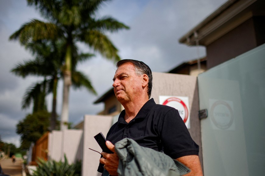 Former Brazilian President Jair Bolsonaro stands in front of his house before testifying to the Federal Police in Brasilia, Brazil, February 22, 2024. REUTERS/Adriano Machado