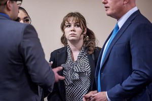 Hannah Gutierrez-Reed (center) talks with her attorney Jason Bowles (right) and her defense team during the trial against her in First District Court, in Santa Fe, N.M. on Friday, March, 1, 2024. Gutierrez-Reed, who was working as the armorer on the movie "Rust" when cinematographer Halyna Hutchins was killed by a misfire, is charged with involuntary manslaughter and tampering with evidence.    Jim Weber/Pool via REUTERS