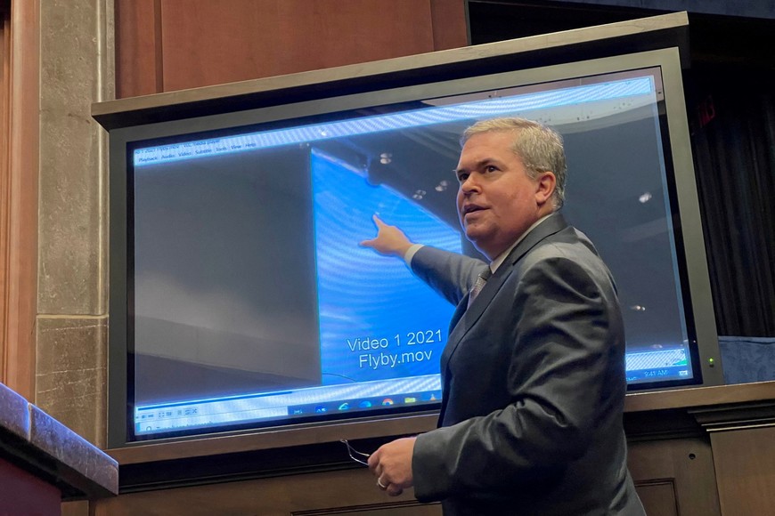 FILE PHOTO: Deputy Director of U.S. Naval Intelligence Scott Bray points to a video of a 'flyby' as he testifies before a House Intelligence Counterterrorism, Counterintelligence, and Counterproliferation Subcommittee hearing about "Unidentified Aerial Phenomena,"  in the first open congressional hearing on 'UFOs' in more than half-century, on Capitol Hill in Washington, U.S., May 17, 2022. REUTERS/Joey Roulette/File Photo