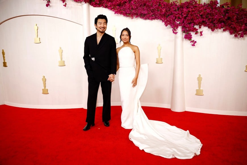 Simu Liu and Allison Hsu pose on the red carpet during the Oscars arrivals at the 96th Academy Awards in Hollywood, Los Angeles, California, U.S., March 10, 2024. REUTERS/Sarah Meyssonnier