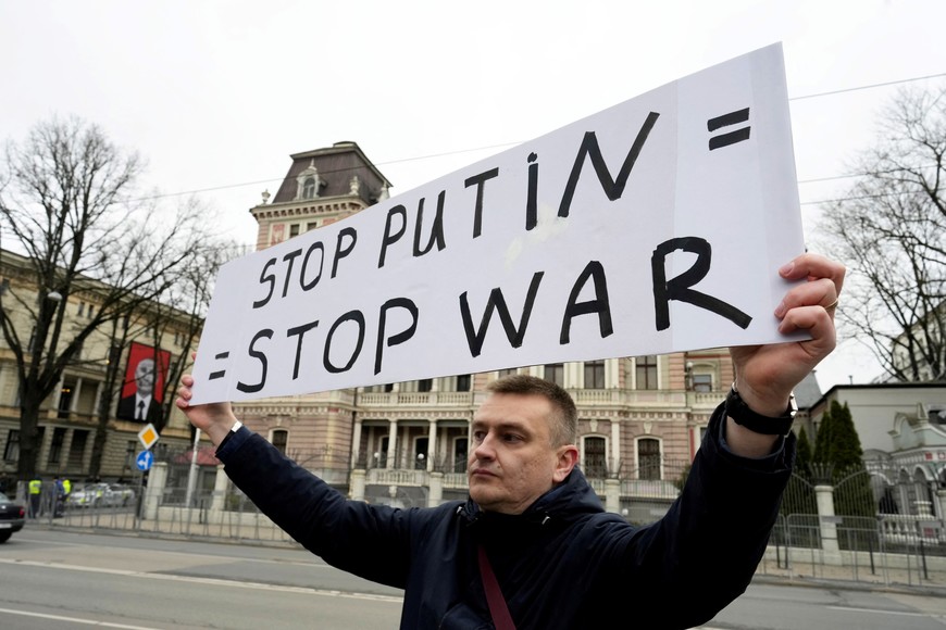 Late Russian opposition leader Alexei Navalny's supporter holds a placard at the front of the Russian Embassy in Riga, Latvia, March 17, 2024. REUTERS/Ints Kalnins