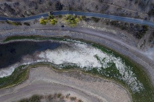 An aerial view shows low water levels at the Rungue reservoir during a drought in Rungue, north of Santiago, Chile, April 11, 2022. Picture taken with a drone. REUTERS/Pablo Sanhueza