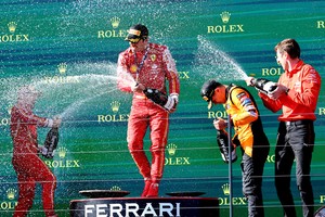 Formula One F1 - Australian Grand Prix - Melbourne Grand Prix Circuit, Melbourne, Australia - March 24, 2024
Ferrari's Carlos Sainz Jr. sprays sparkling wine and celebrates on the podium after winning the Australian Grand Prix along with second placed Ferrari's Charles Leclerc and third placed McLaren's Lando Norris REUTERS/Mark Peterson