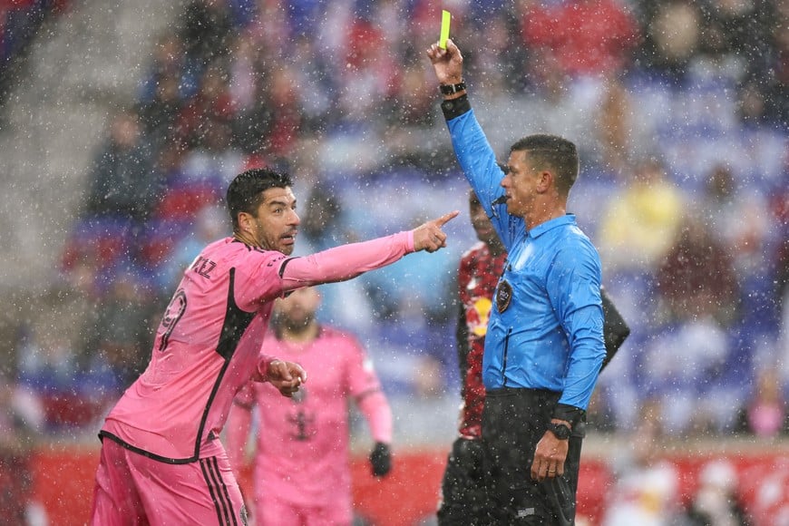 Mar 23, 2024; Harrison, New Jersey, USA; Referee Rafael Santos shows a yellow card to Inter Miami CF forward Luis Suarez (9) in the first half against the New York Red Bulls at Red Bull Arena. Mandatory Credit: Vincent Carchietta-USA TODAY Sports