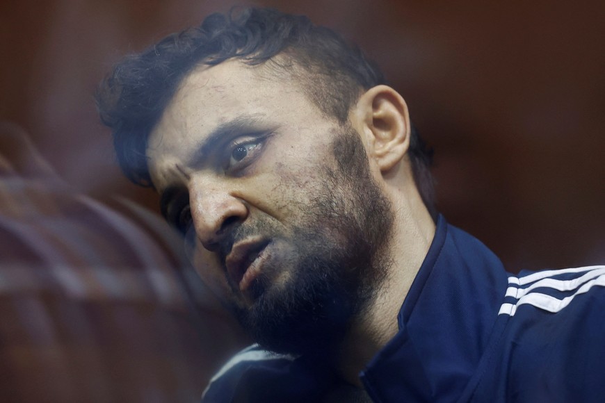 Dalerdzhon Mirzoyev, a suspect in the shooting attack at the Crocus City Hall concert venue, sits behind a glass wall of an enclosure for defendants at the Basmanny district court in Moscow, Russia March 24, 2024. REUTERS/Yulia Morozova