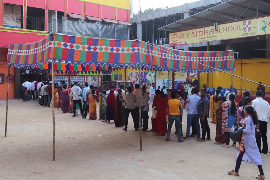 People stand in a queue to cast their vote outside a polling station during the Telangana Legislative Assembly election in Hyderabad, India, November 30, 2023. REUTERS/Almaas Masood