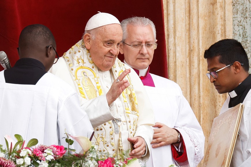 Pope Francis gestures from a balcony at St. Peter's Square, on Easter Sunday, at the Vatican March 31, 2024. REUTERS/Remo Casilli