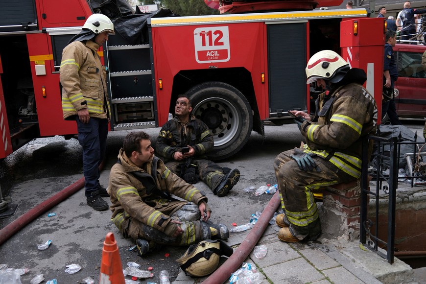 Firefighters pause as they work at a building where a fire broke out during daytime renovation work at a nightclub in Istanbul, Turkey April 2, 2024. REUTERS/Murad Sezer