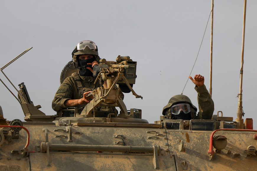 Israeli military personnel drive an armoured personnel carrier (APC) near the Israel-Gaza border, amid the ongoing conflict between Israel and the Palestinian Islamist group Hamas, as seen from Israel April 3, 2024. REUTERS/Hannah McKay