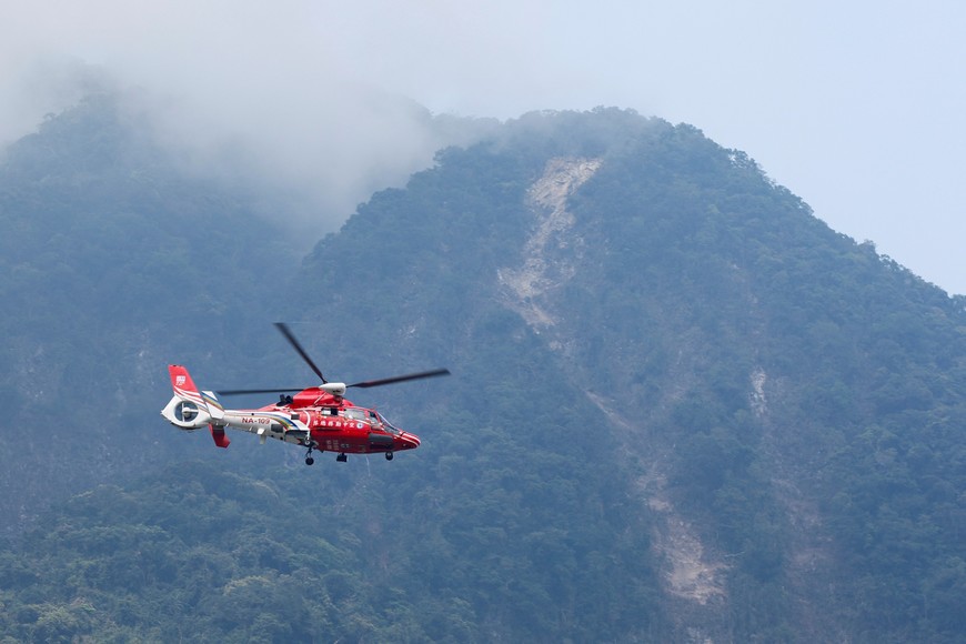 A rescue helicopter flies past the area of a landslide, following the earthquake, in Hualien, Taiwan, April 4, 2024. REUTERS/Tyrone Siu