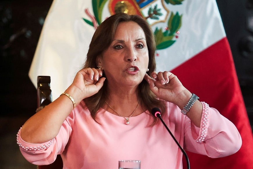 Peru's President Dina Boluarte shows her earrings during a press conference at the government palace after her statement to the prosecutor's office hearing on an investigation for the possession of expensive jewellery, including Rolex watches and a Cartier bracelet, in Lima, Peru April 5, 2024. REUTERS/Sebastian Castaneda
