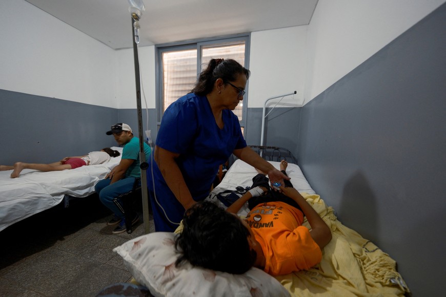Nurse Zulma Arraya provides treatment to dengue-infected Angel Benjamin Sarabia, at the Dr. Oscar H. Costas Hospital, in Joquin V. Gonzalez, Salta, Argentina March 16, 2024. REUTERS/Javier Corbalan