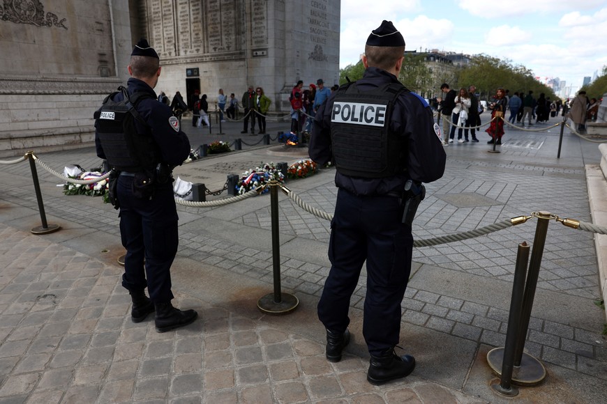 French police patrol near the Tomb of the Unknown Soldier at the Arc de Triomphe ahead of the Champions League quarter-final between Paris St Germain and FC Barcelona soccer teams in Paris, France, April 10, 2024. REUTERS/Stephanie Lecocq