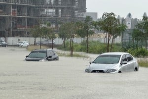 Cars drive through a flooded street during a rain storm in Dubai, United Arab Emirates, April 16, 2024. REUTERS/Abdel Hadi Ramahi