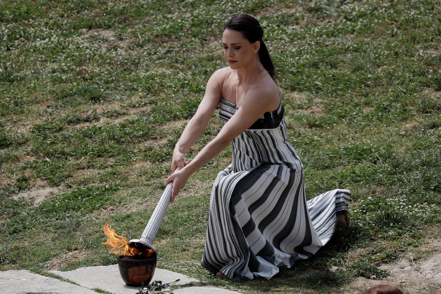 Paris 2024 Olympics - Olympic Flame Lighting Ceremony - Ancient Olympia, Greece - April 16, 2024
Greek actress Mary Mina, playing the role of High Priestess, lights the flame during the Olympic Flame lighting ceremony for the Paris 2024 Olympics. REUTERS/Louisa Gouliamaki