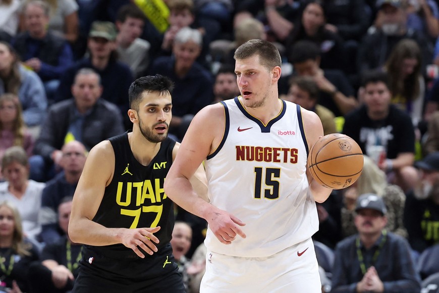 Apr 9, 2024; Salt Lake City, Utah, USA; Denver Nuggets center Nikola Jokic (15) looks to pass against Utah Jazz center Omer Yurtseven (77) during the third quarter at Delta Center. Mandatory Credit: Rob Gray-USA TODAY Sports