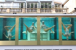 Former British Olympic artistic swimmers Asha George and Katie Clark together with Sisy Wang and Emily Kuhl, all of Aquabatix, perform in a large water tank to mark 100 days before the 2024 Paris Olympic Games starts, at Covent Garden in London, Britain, April 17, 2024. REUTERS/Toby Melville