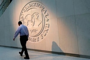 A man walks past the International Monetary Fund (IMF) logo at its headquarters in Washington, U.S., May 10, 2018. REUTERS/Yuri Gripas