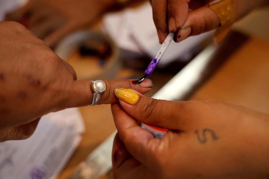 A woman gets her finger inked before casting her vote at a polling station during the first phase of general election, in Alipurduar district in the eastern state of West Bengal, India, April 19, 2024. REUTERS/Sahiba Chawdhary