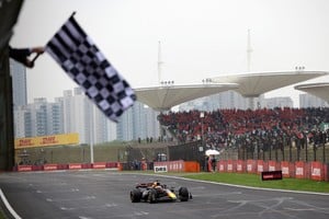 La bandera a cuadros para recibir a Verstappen, el gran ganador en la competencia del domingo último en China. Reuters 