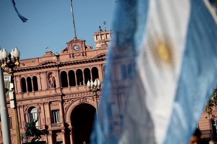 Argentine flag flutters in front of Casa Rosada government house as university students, unions and social groups march to protest against President Javier Milei's "chainsaw" cuts on public education, in Buenos Aires, Argentina, April 23, 2024. REUTERS/Agustin Marcarian