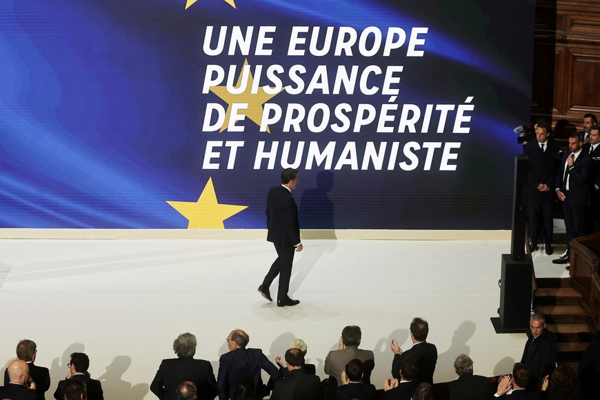 French President Emmanuel Macron leaves the stage next to a slogan reading 'A Europe of humanist prosperity' at the end of his speech on Europe in the amphitheatre of the Sorbonne University in Paris, France, 25 April 2024. Christophe Petit Tesson/Pool via REUTERS