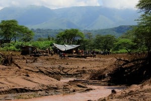 Residents gather at the ruins of a home in search of people after heavy flash floods wiped out several homes when a dam burst, following heavy rains in Kamuchiri village of Mai Mahiu, Nakuru County, Kenya April 29, 2024. REUTERS/Thomas Mukoya