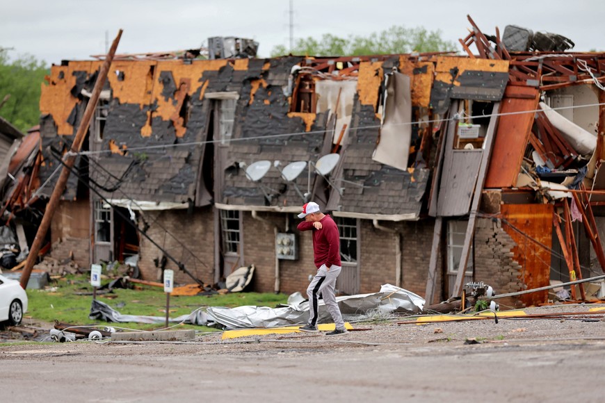 A man walks past a damaged building after it was hit by a tornado the night before in Sulphur, Oklahoma, U.S. April 28, 2024.   Bryan Terry/The Oklahoman/USA Today Network via REUTERS
NO RESALES. NO ARCHIVES. MANDATORY CREDIT