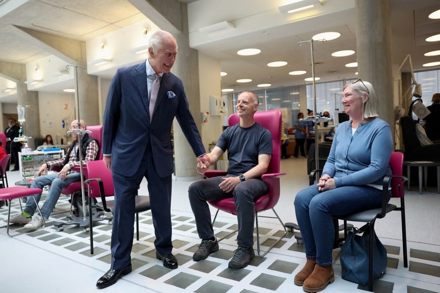 Britain's King Charles greets patient Huw Stiley as he meets with patient during a visit to the University College Hospital Macmillan Cancer Centre in London, Britain, April 30, 2024. REUTERS/Suzanne Plunkett/Pool