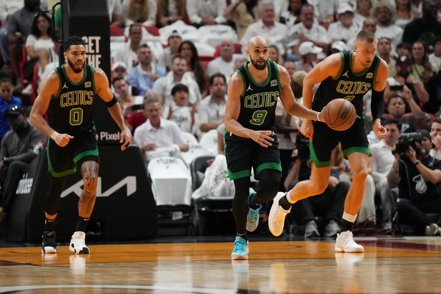 Apr 27, 2024; Miami, Florida, USA; Boston Celtics guard Derrick White (9) brings the ball up the court against the Miami Heat in the first half during game three of the first round for the 2024 NBA playoffs at Kaseya Center. Mandatory Credit: Jim Rassol-USA TODAY Sports