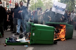 A dumpster on fire as people attend the traditional May Day labour union march in Paris, France, May 1, 2024. REUTERS/Stephanie Lecocq