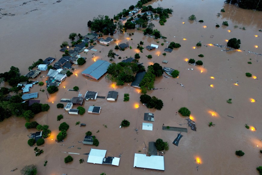 A drone view shows houses in the flooded area next to the Taquari River during heavy rains in the city of Encantado in Rio Grande do Sul, Brazil, May 1, 2024. REUTERS/Diego Vara