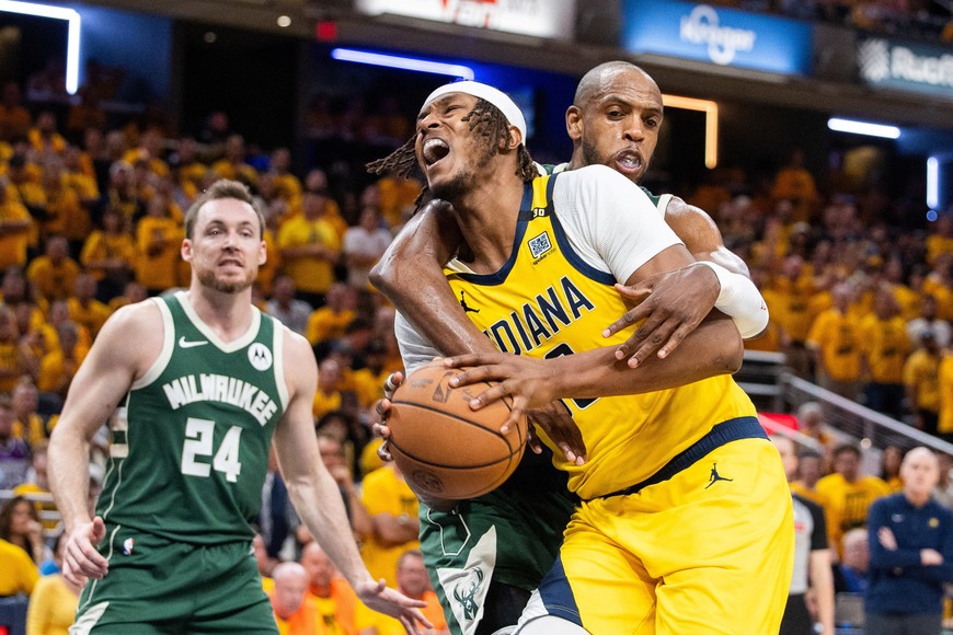 May 2, 2024; Indianapolis, Indiana, USA; Indiana Pacers center Myles Turner (33) is fouled by Milwaukee Bucks forward Khris Middleton (22) during game six of the first round for the 2024 NBA playoffs at Gainbridge Fieldhouse. Mandatory Credit: Trevor Ruszkowski-USA TODAY Sports
