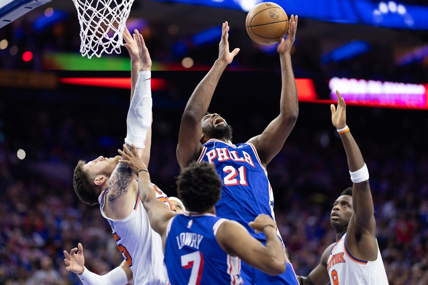 May 2, 2024; Philadelphia, Pennsylvania, USA; Philadelphia 76ers center Joel Embiid (21) reaches for a rebound against New York Knicks center Isaiah Hartenstein (55) during the second half of game six of the first round for the 2024 NBA playoffs at Wells Fargo Center. Mandatory Credit: Bill Streicher-USA TODAY Sports