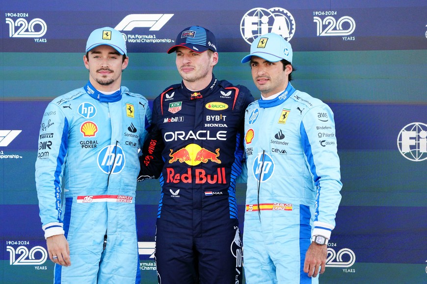 May 4, 2024; Miami Gardens, Florida, USA; Ferrari driver Charles Leclerc (16) , Red Bull Racing driver Max Verstappen (1) and Ferrari driver Carlos Sainz (55) pose for a photo int he paddock after qualifying for the Miami Grand Prix at Miami International Autodrome. Mandatory Credit: John David Mercer-USA TODAY Sports
