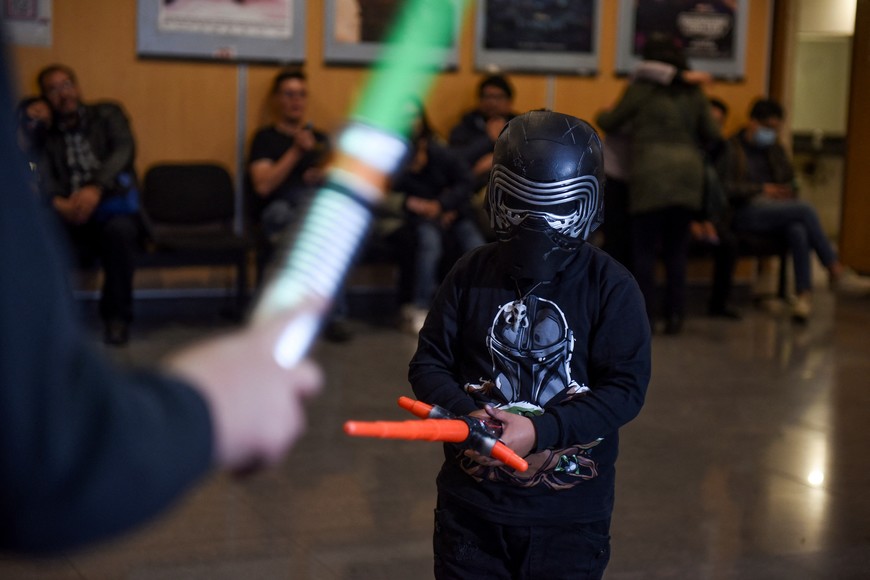 A boy dressed as a "Star Wars" character interacts with a person during International Star Wars Day, in La Paz, Bolivia, May 4, 2023. REUTERS/Claudia Morales