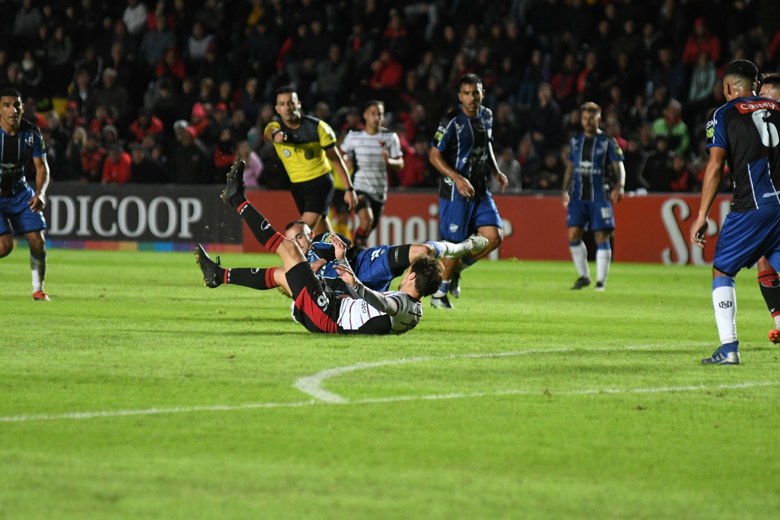 Bernardi al piso y el polémico árbitro "Lobo" Medina da la señal del siga, siga.