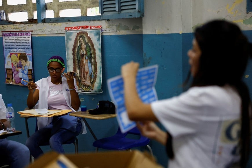 Polling station staff members work on counting on the day of the general election, in Panama City, Panama, May 5, 2024. REUTERS/Daniel Becerril