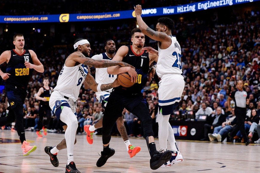 May 6, 2024; Denver, Colorado, USA; Minnesota Timberwolves guard Nickeil Alexander-Walker (9) steals the ball away from Denver Nuggets forward Michael Porter Jr. (1) as guard Monte Morris (23) defends in the third quarter during game two of the second round for the 2024 NBA playoffs at Ball Arena. Mandatory Credit: Isaiah J. Downing-USA TODAY Sports