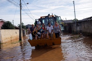 Evacuees ride in a tractor after their homes were flooded at Eldorado do Sul, in Rio Grande do Sul Brazil May 7, 2024. REUTERS/Amanda Perobelli