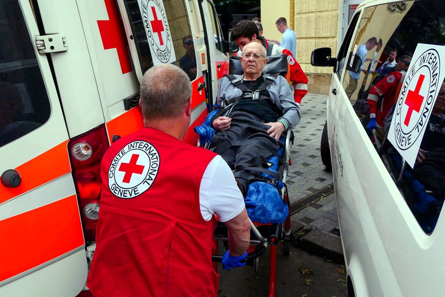 Members of the Red Cross transport on a stretcher a man with disability, who was evacuated from a frontline area, amid Russia's invasion of Ukraine, in Odesa, Ukraine, May 14, 2022. REUTERS/Igor Tkachenko