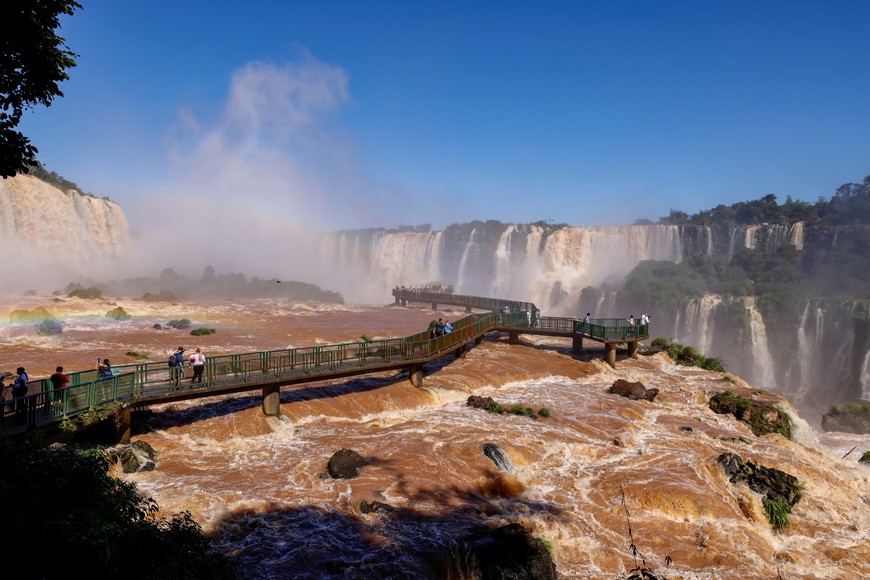 People tour Iguazu Falls, which are currently at full water capacity due to the rains in southern Brazil, at Iguazu Falls, Brazil, May 7, 2024. REUTERS/Kiko Sierich